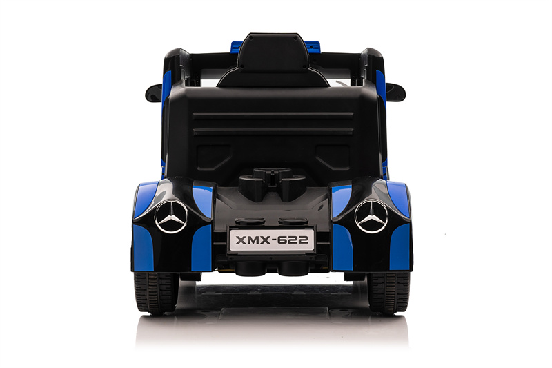 Child driving a Mercedes Benz ride-on car outdoors